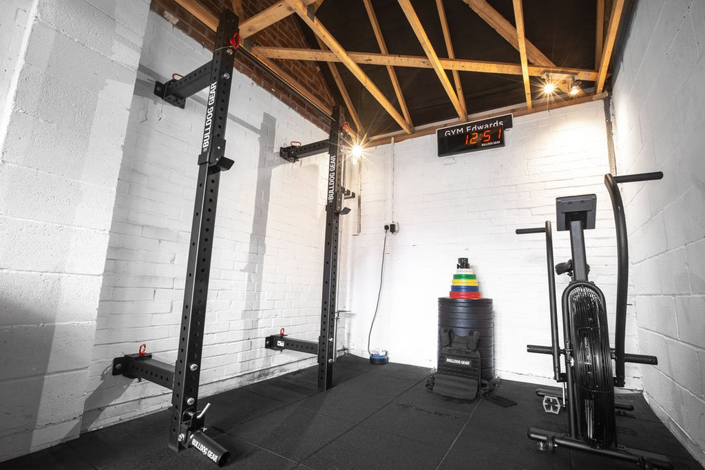 Bulldog Gear mammoth lite wall mounted folding rack installed in a small garage gym.