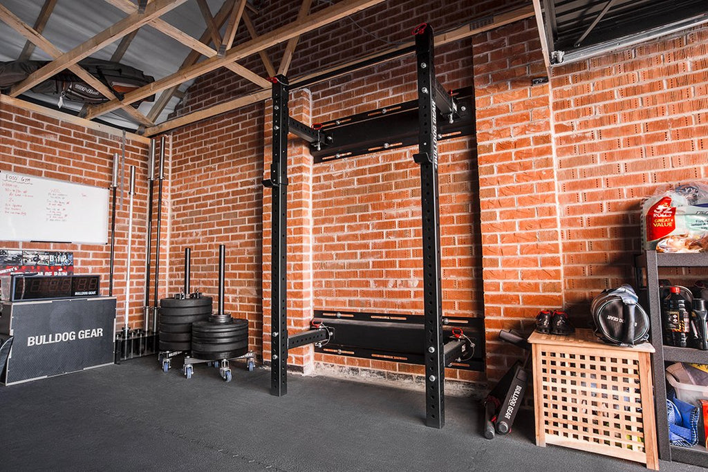 Bulldog Gear mammoth lite wall mounted folding rack installed in a garage gym.