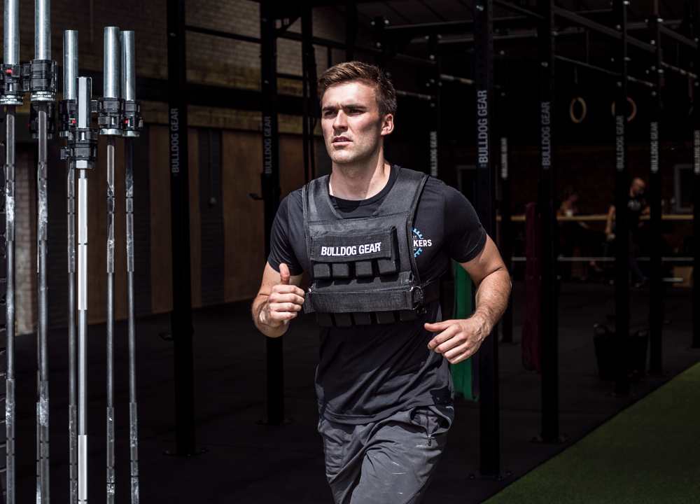 Male athlete running in a Bulldog Gear weight vest