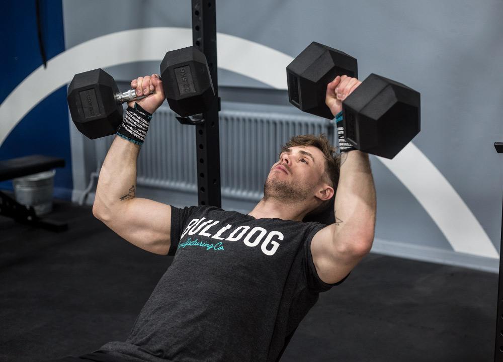 Man using 22.5kg Bulldog Gear hex dumbbells for incline bench press